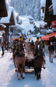 adelboden village with horses in snow