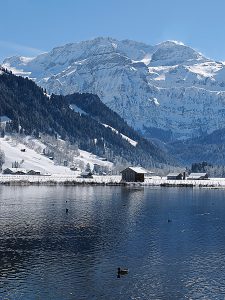 lenk lake and snowy mountains